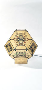 Illuminated kaleidoscope-style shadow lamp with a geometric mushroom design projecting colorful patterns on walls and ceiling.