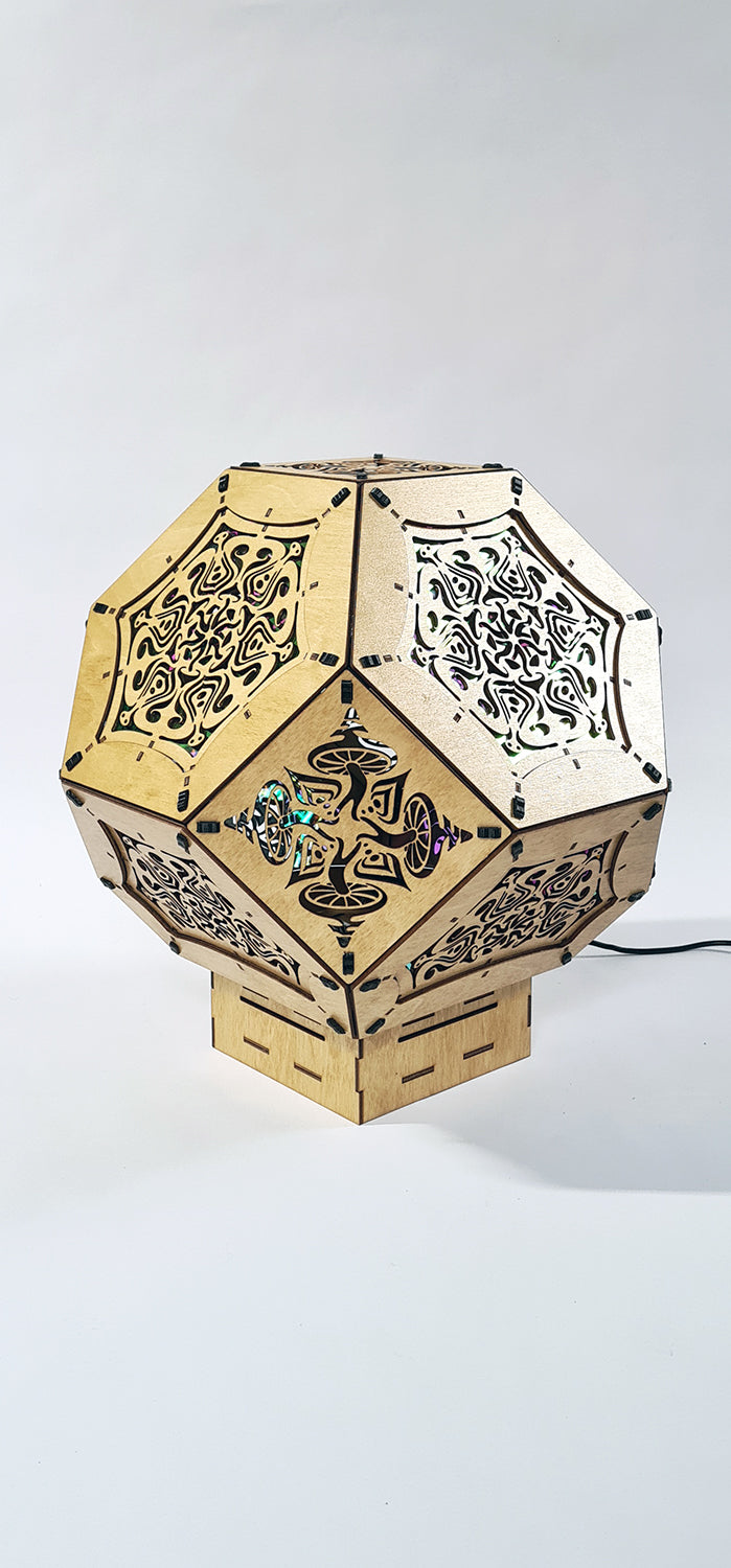 Illuminated kaleidoscope-style shadow lamp with a geometric mushroom design projecting colorful patterns on walls and ceiling.