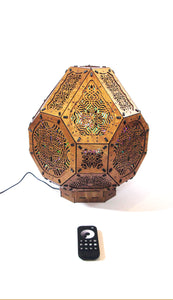 A colorful shadow lamp projecting intricate geometric patterns on a wall, with the lamp in the foreground.