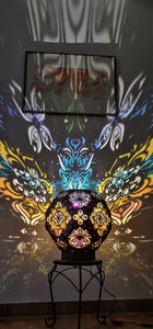 Psychedelic wooden geometric shadow lamp that projects colorful trippy shadows onto the walls