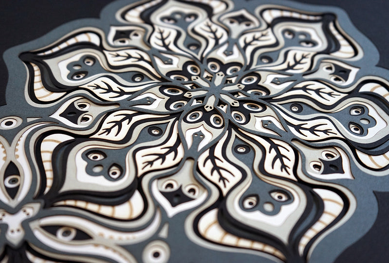 Monochromatic layered paper artwork depicting organic ornamental mandala made in Czech republic