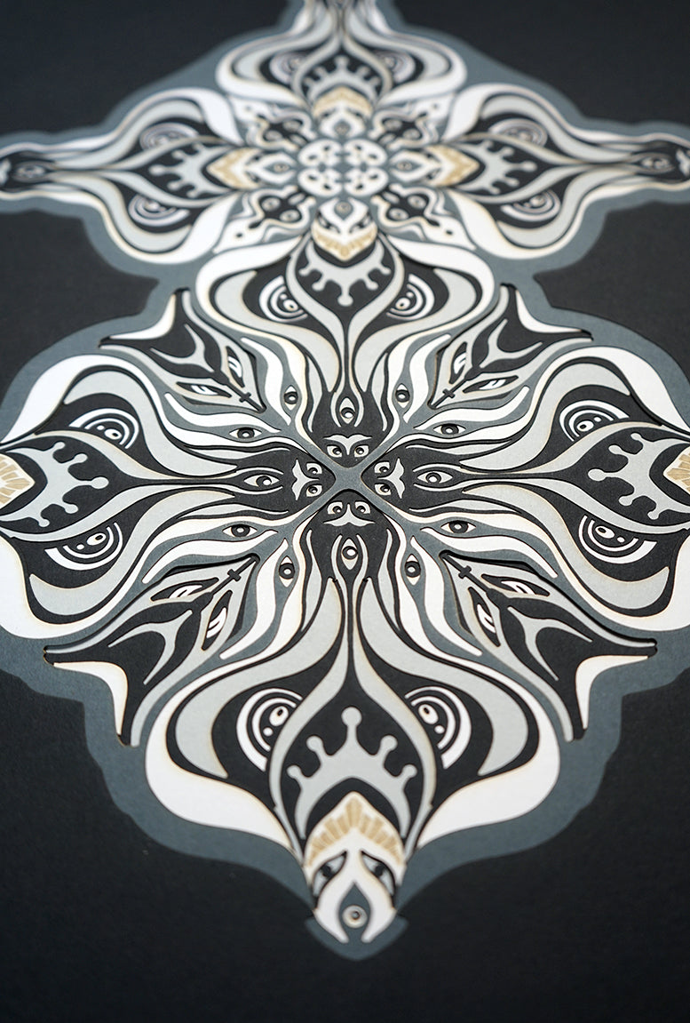 Layered grayscale paper artwork from the Metamorphs series where mandala geometry shifts into creature like spirits.