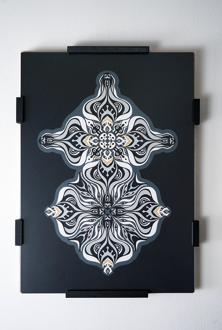 Layered grayscale paper artwork from the Metamorphs series where mandala geometry shifts into creature like spirits.