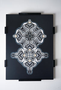 Layered grayscale paper artwork from the Metamorphs series where mandala geometry shifts into creature like spirits.