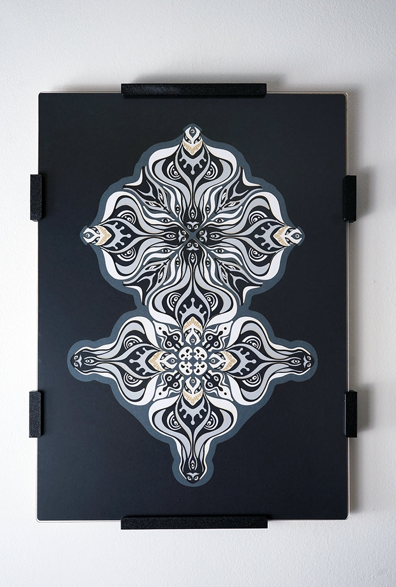 Layered grayscale paper artwork from the Metamorphs series where mandala geometry shifts into creature like spirits.