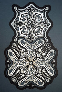 Monochrome layered paper artwork titled Metamorphs, made of intricate geometric mandalas that reveal totemic faces.