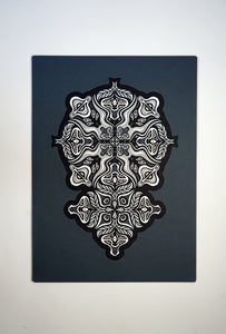 Monochrome layered paper artwork from the Metamorphs series, featuring interlocking mandalas that form hidden animal and spirit faces.