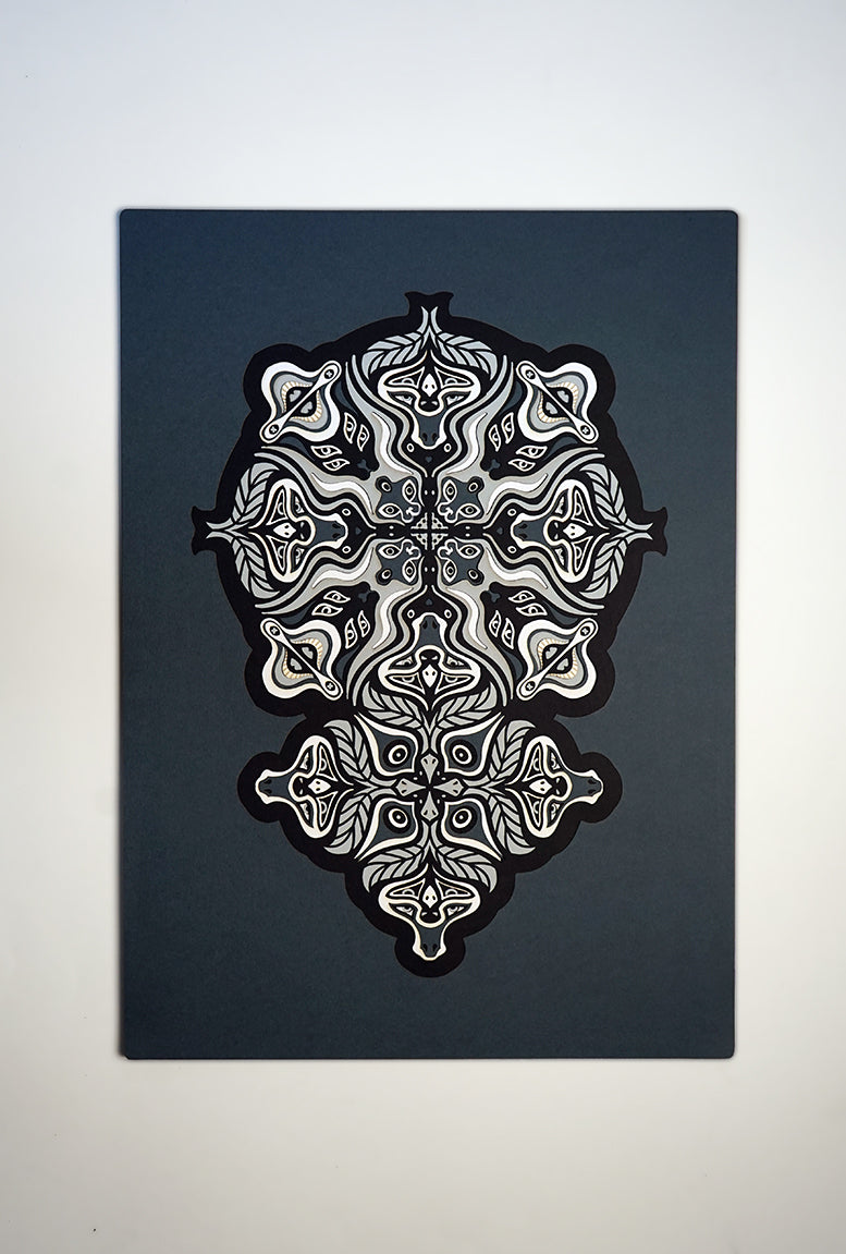 Monochrome layered paper artwork from the Metamorphs series, featuring interlocking mandalas that form hidden animal and spirit faces.