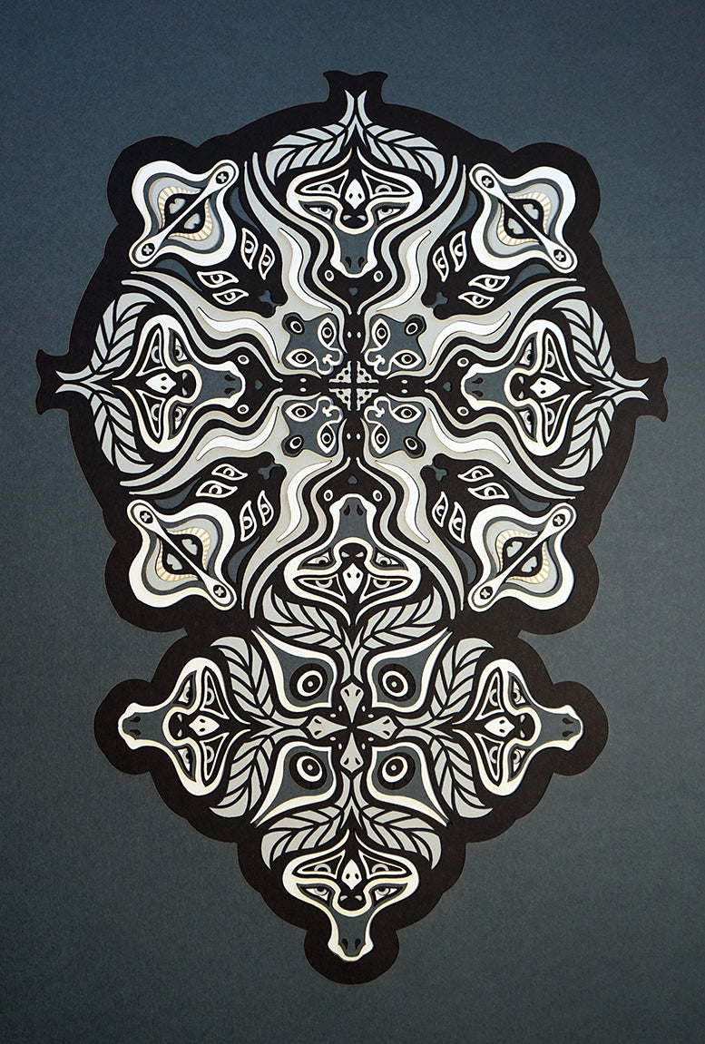 Monochrome layered paper artwork from the Metamorphs series, featuring interlocking mandalas that form hidden animal and spirit faces.