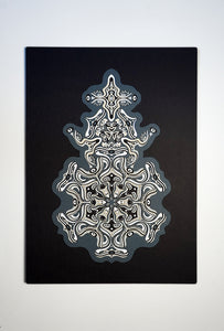 Intricate monochrome paper layers arranged in a mandala structure, creating emerging spirit faces and abstract creatures.