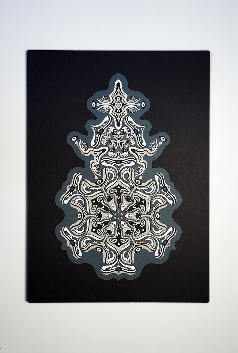 Intricate monochrome paper layers arranged in a mandala structure, creating emerging spirit faces and abstract creatures.