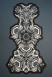 Black and white layered paper mandala with emerging animal spirit faces, part of the Metamorphs collection.