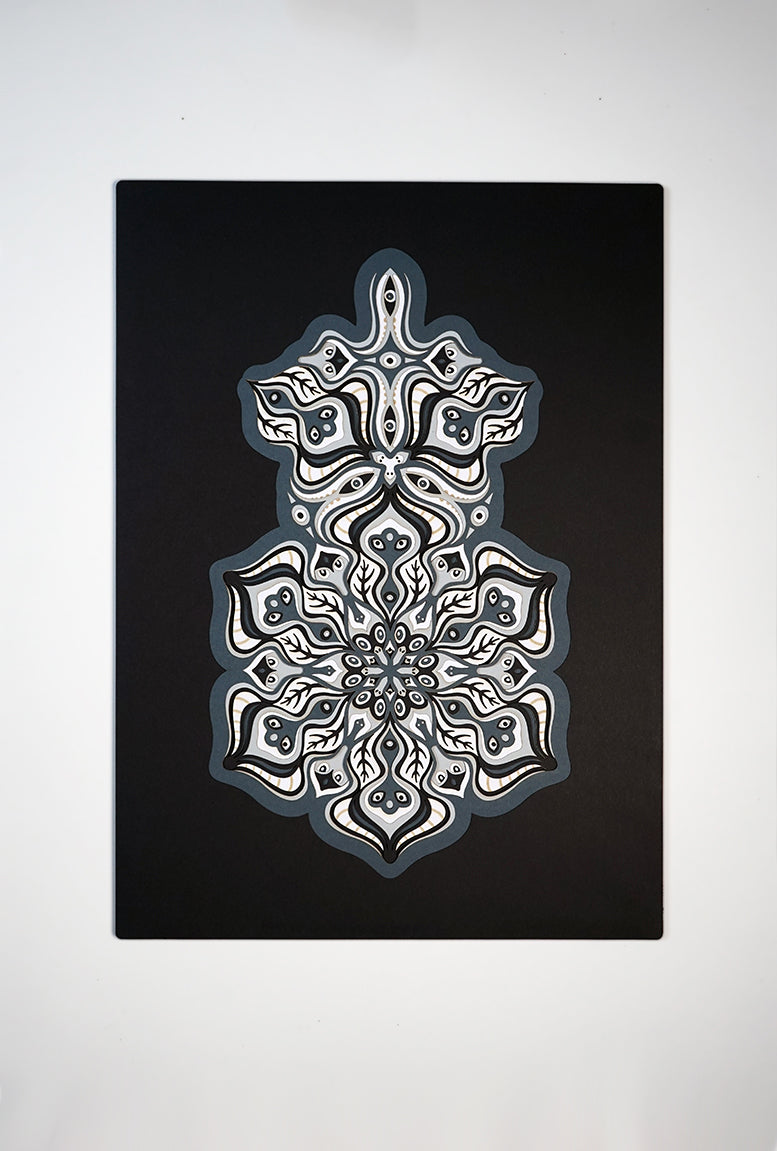 Complex black and white paper layers forming interconnected mandalas that hide subtle morphing faces.