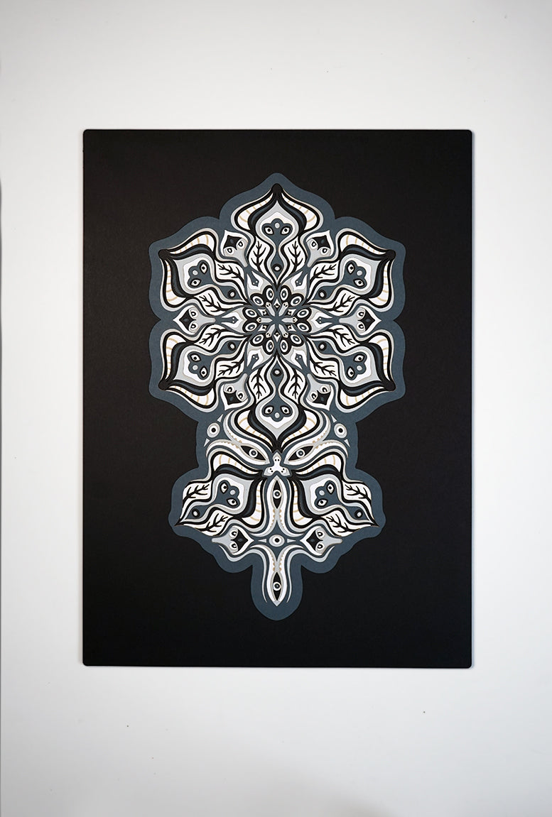 Complex black and white paper layers forming interconnected mandalas that hide subtle morphing faces.