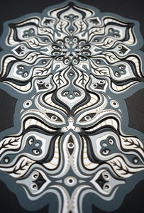 Complex black and white paper layers forming interconnected mandalas that hide subtle morphing faces.