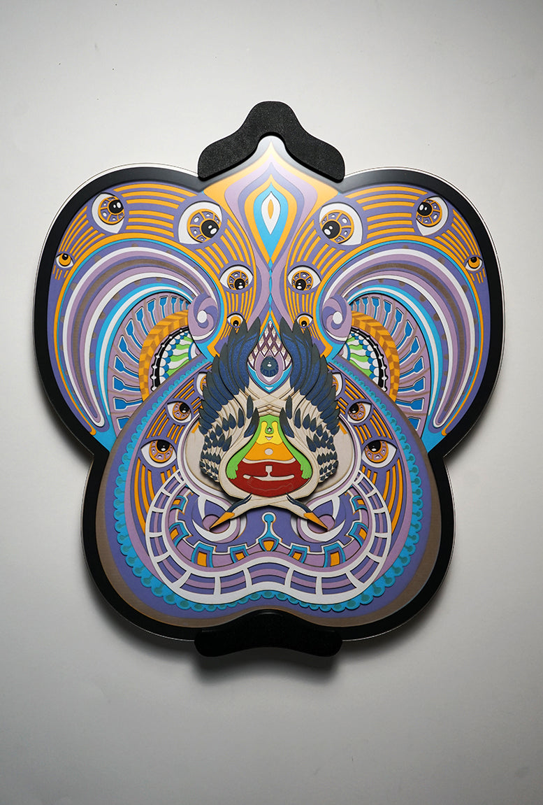 Visionary papercut artwork of a meditating figure with chakras and herons, representing oneness, enlightenment, and cosmic flow.