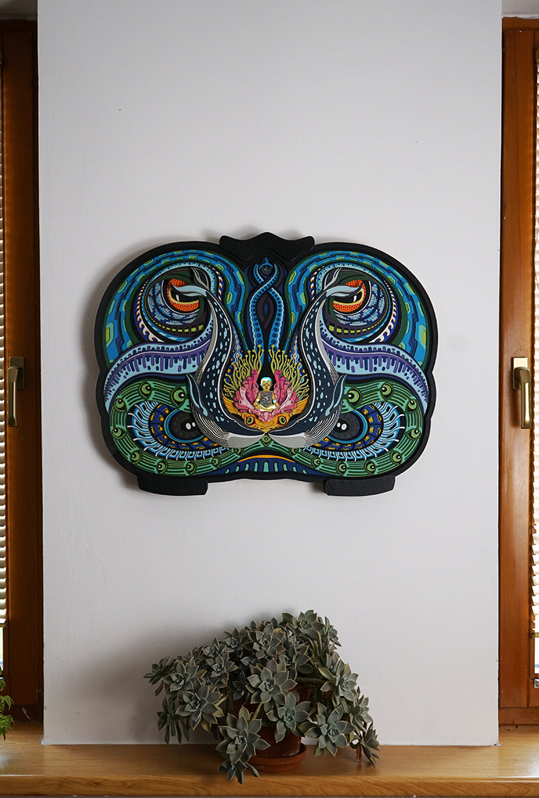 Layered paper art of infant on coral throne with whales and ocean patterns, symbolizing life’s origin and unity.