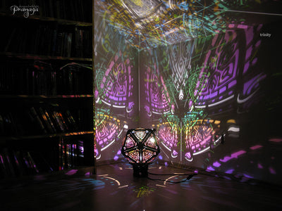 A colorful shadow lamp with a three-petal flower design, projecting vibrant rainbow shadows on the wall