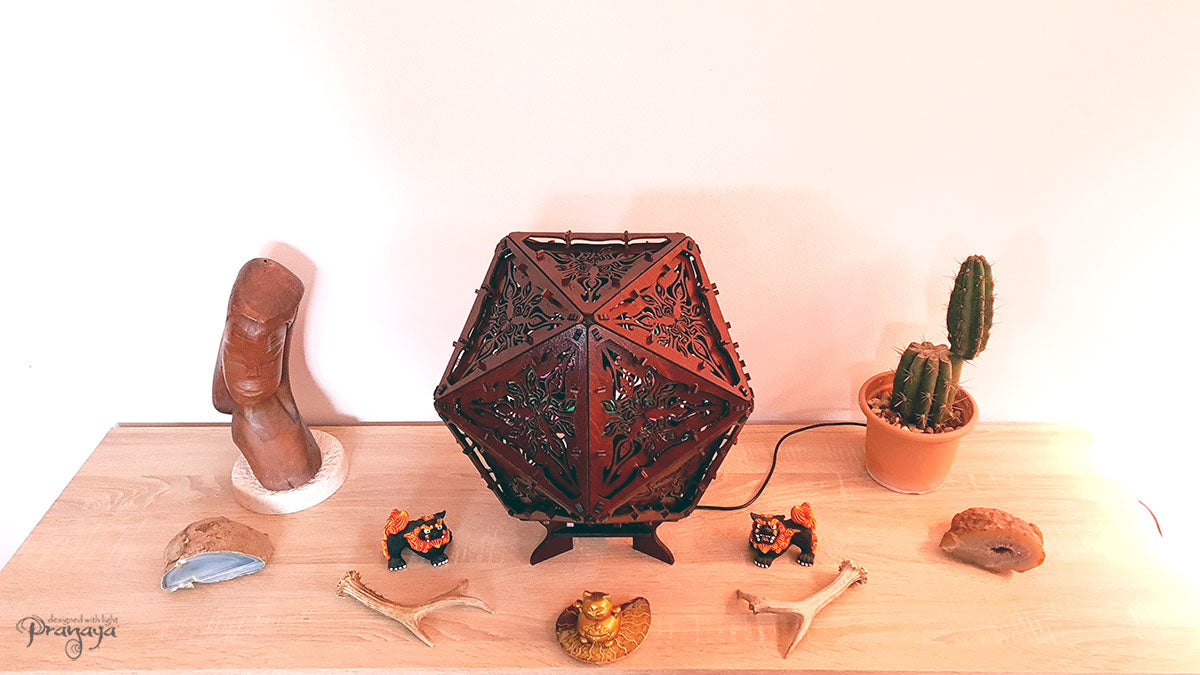 Psychedelic geometric wooden shadow lamp that projects crispy flower reminiscent mandalas onto the walls