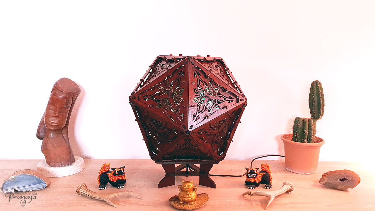 Psychedelic geometric wooden shadow lamp that projects crispy flower reminiscent mandalas onto the walls