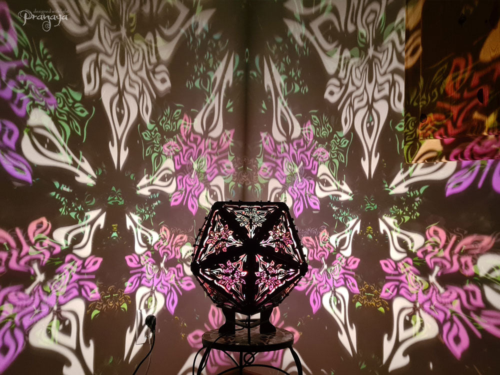 Psychedelic geometric wooden shadow lamp that projects crispy flower reminiscent mandalas onto the walls