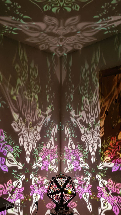 Psychedelic geometric wooden shadow lamp that projects crispy flower reminiscent mandalas onto the walls