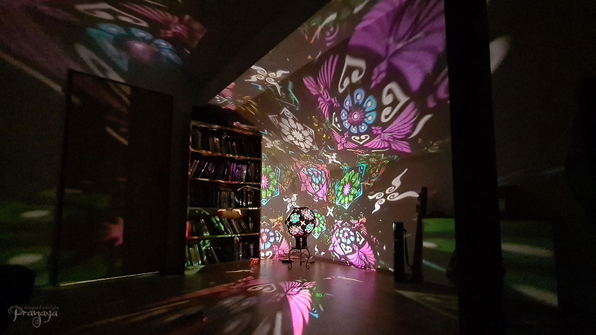 A psychedelic geometric shadow lamp projecting colorful cactus mandalas on the walls
