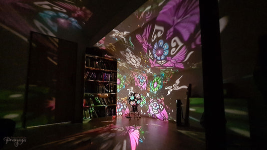A psychedelic geometric shadow lamp projecting colorful cactus mandalas on the walls