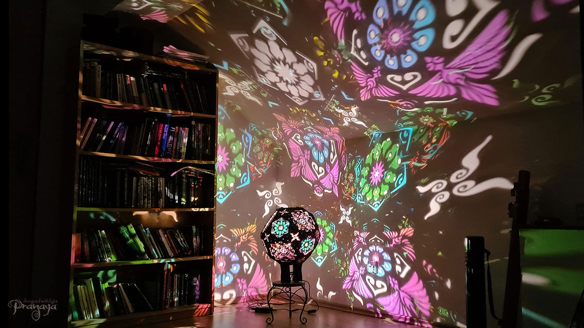A psychedelic geometric shadow lamp projecting colorful cactus mandalas on the walls