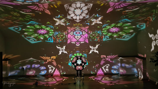 A psychedelic geometric shadow lamp projecting colorful cactus mandalas on the walls