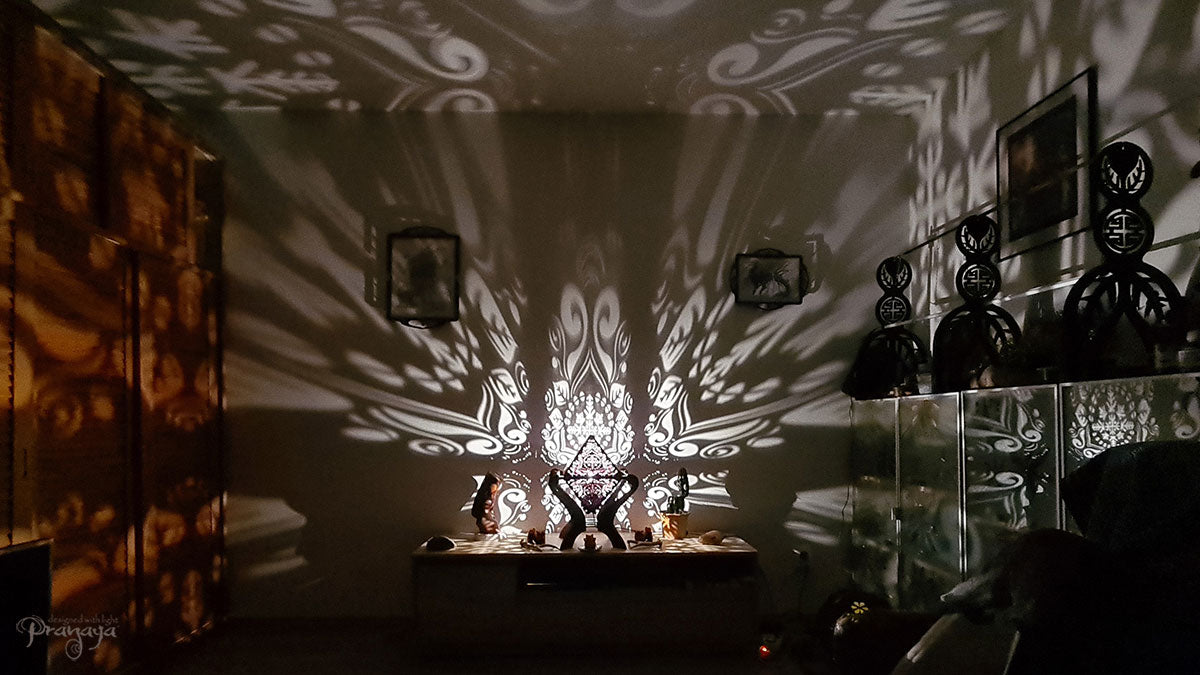 Octahedron wooden shadow lamp projecting a geometric pattern on a wall.