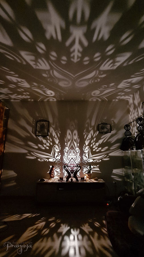 Octahedron wooden shadow lamp projecting a geometric pattern on a wall.