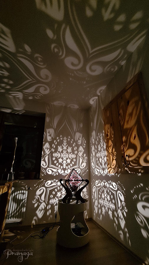 Octahedron wooden shadow lamp projecting a geometric pattern on a wall.
