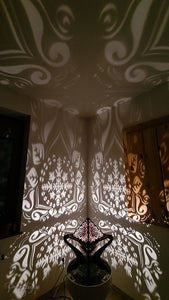 Octahedron wooden shadow lamp projecting a geometric pattern on a wall.