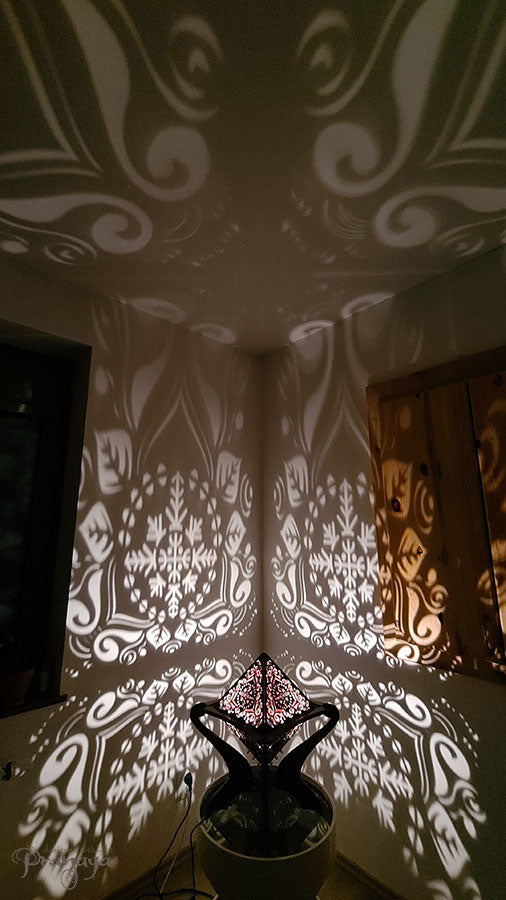 Octahedron wooden shadow lamp projecting a geometric pattern on a wall.