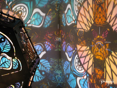 Geometric shadow lamp that projects colorful iridescent mandalas with leaves on the wall