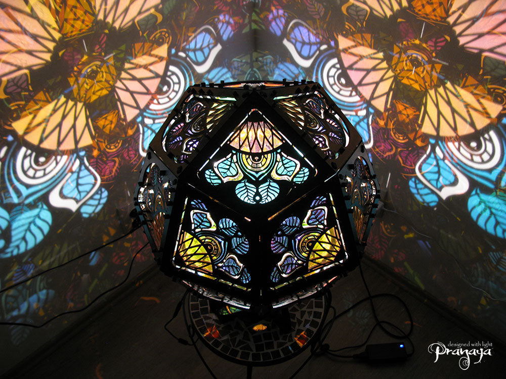 Geometric shadow lamp that projects colorful iridescent mandalas with leaves on the wall