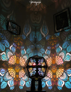 Geometric shadow lamp that projects colorful iridescent mandalas with leaves on the wall