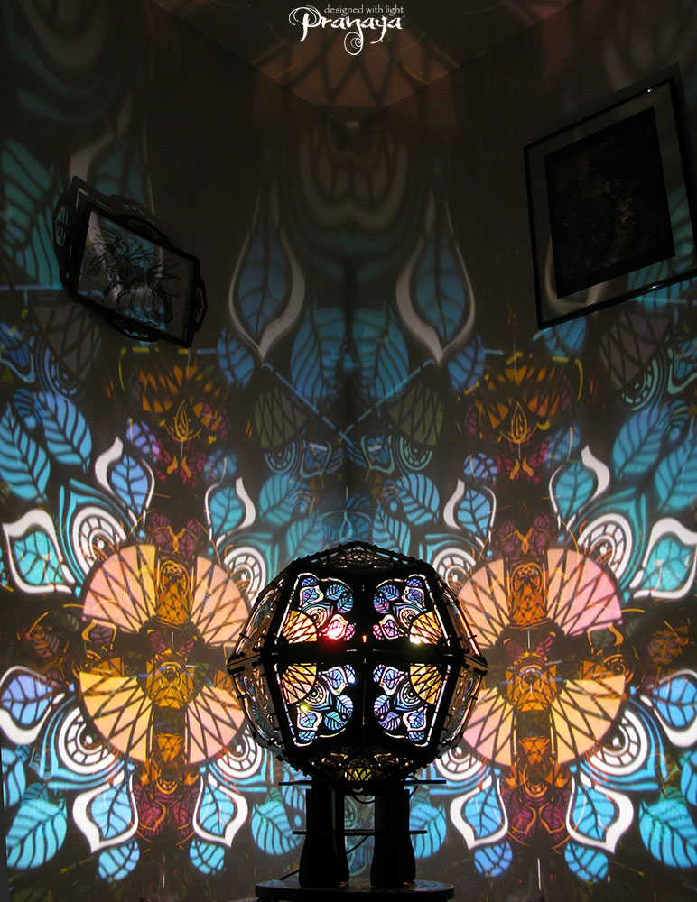 Geometric shadow lamp that projects colorful iridescent mandalas with leaves on the wall