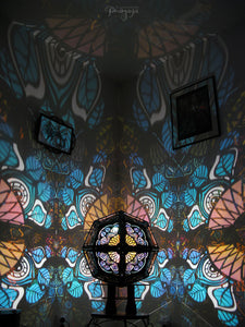 Geometric shadow lamp that projects colorful iridescent mandalas with leaves on the wall