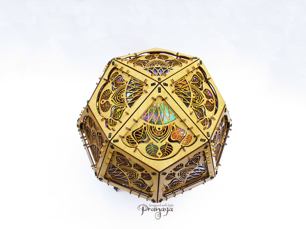 Geometric shadow lamp that projects colorful iridescent mandalas with leaves on the wall