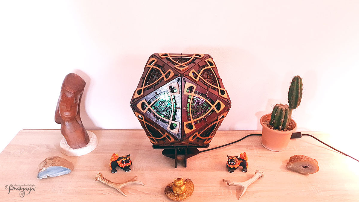 A colorful shadow lamp with a three-petal flower design, projecting vibrant rainbow shadows on the wall