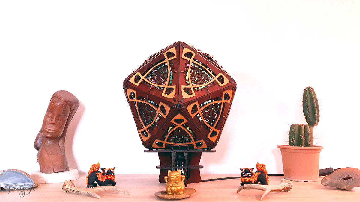 A colorful shadow lamp with a three-petal flower design, projecting vibrant rainbow shadows on the wall