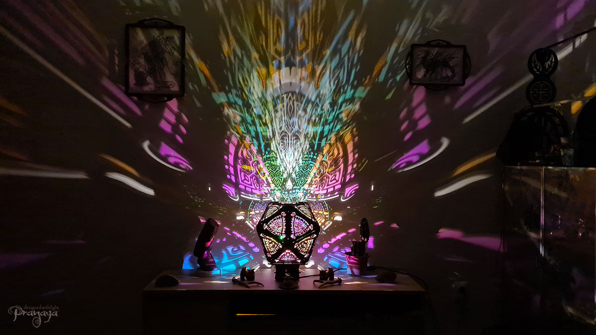 A colorful shadow lamp with a three-petal flower design, projecting vibrant rainbow shadows on the wall