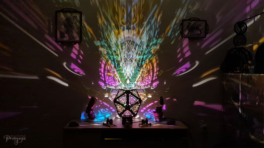 A colorful shadow lamp with a three-petal flower design, projecting vibrant rainbow shadows on the wall