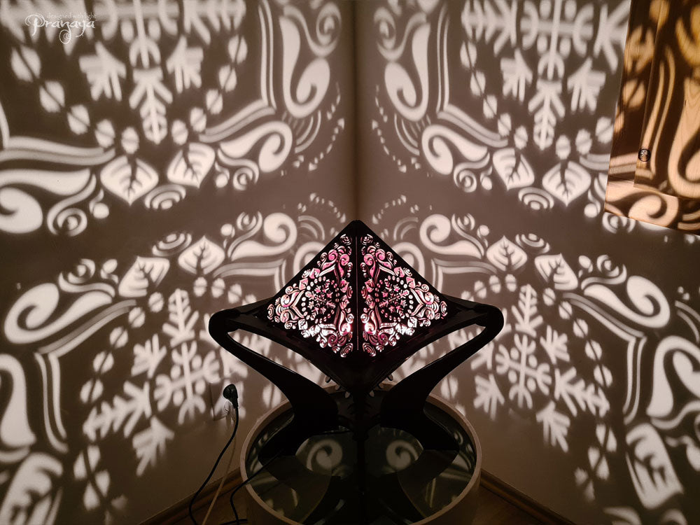 Octahedron wooden shadow lamp projecting a geometric pattern on a wall.